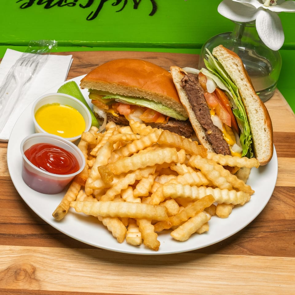 Cheeseburger with lettuce, tomato, and onion served with crinkle-cut fries and dipping sauces.