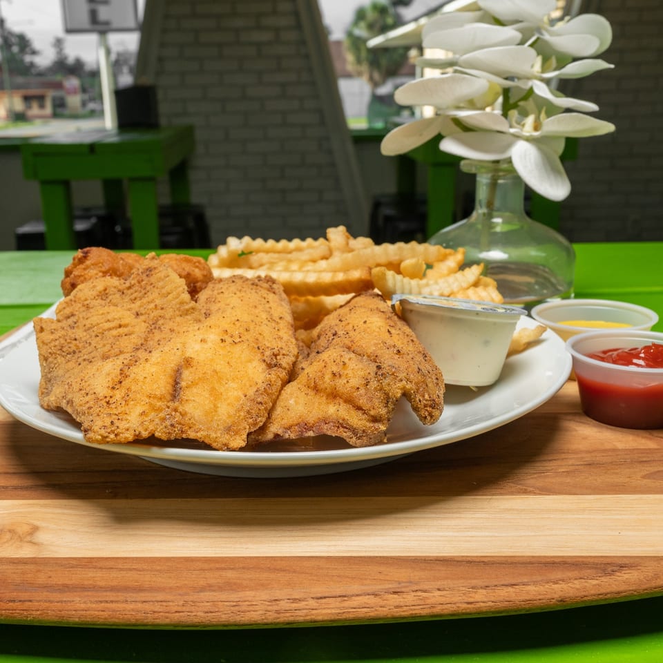 Golden fried fish combo served with crinkle-cut fries and dipping sauces.