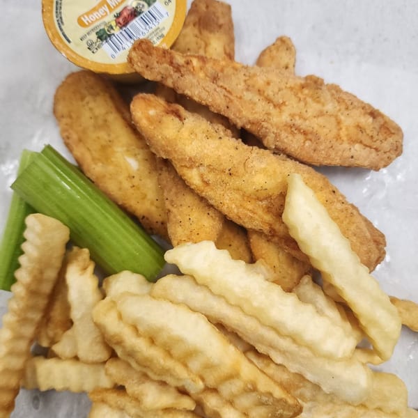 Crispy fried chicken tenders, crinkle-cut fries, celery sticks, and a honey mustard dipping sauce cup.